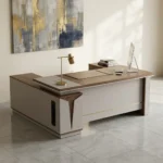 1800mm L-shaped executive desk featuring a modern two-tone design with a rich dark wood-grain tabletop and matte light-beige panels, an integrated side return cabinet with a vertical black ventilation detail, an embedded writing pad, a rectangular silver cable management cover, and a full modesty panel highlighted by a thin gold accent line.