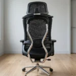 Ergonomic orthopedic office staff chair featuring a high-back design with an adjustable mesh headrest, a contoured black mesh backrest supported by an integrated skeletal lumbar structure, flat T-shaped adjustable armrests, a thickly cushioned black fabric seat, and a polished aluminum five-star swivel base on dual-wheel casters.