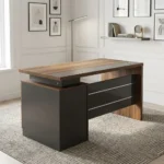 140cm executive office desk featuring a modern two-tone design with a warm wood-grain tabletop, a blocky charcoal-gray side pedestal cabinet on the left supporting a floating-style top, a matching wood-grain right leg panel, and a front modesty panel in charcoal-gray accented by two horizontal silver stripes.