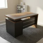 140cm executive office desk featuring a modern two-tone design with a warm wood-grain tabletop, a blocky charcoal-gray side pedestal cabinet on the left supporting a floating-style top, a matching wood-grain right leg panel, and a front modesty panel in charcoal-gray accented by two horizontal silver stripes.
