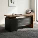 140cm executive office desk featuring a modern two-tone design with a warm wood-grain tabletop, a blocky charcoal-gray side pedestal cabinet on the left supporting a floating-style top, a matching wood-grain right leg panel, and a front modesty panel in charcoal-gray accented by two horizontal silver stripes.