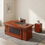 2.0m executive office desk featuring a rich reddish-brown wood-grain finish, an L-shaped layout with an attached side return credenza, an embedded black leather desktop writing pad, a front modesty panel decorated with two columns of segmented black textured panels, and a matching independent three-drawer mobile filing pedestal.