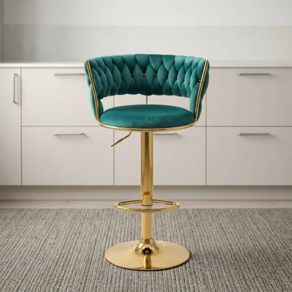 Green fabric adjustable barstool featuring an emerald green velvet-upholstered seat with a woven/braided curved backrest, brushed gold metal framing and trim, a height-adjustment lever, an integrated circular footrest, and a matching gold round pedestal base.