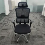 Orthopedic chair with adjustable armrests featuring a split high-back breathable black mesh design with dedicated lumbar support, an adjustable mesh headrest, height-adjustable T-armrests, a cushioned black fabric seat, an under-seat adjustment lever, and a polished metal five-star swivel base with dual-wheel casters.