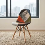 Modern patchwork Eames-style chair featuring a contoured shell seat upholstered in a multi-patterned fabric blend of houndstooth, plaid, and solid earthy tones, supported by natural wood dowel legs with black metal Eiffel-style wire bracing.