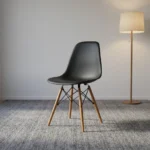 Black Eames-style dining chair featuring a molded matte black polypropylene shell seat, supported by natural wood dowel legs with black metal Eiffel-style wire bracing.