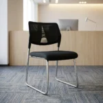 Stackable mesh visitor chair featuring a breathable black mesh backrest with a decorative geometric support accent, a armless design, a padded black fabric seat cushion, and a sleek chrome sled-base frame.
