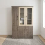 3-door wooden executive cabinet featuring a two-tone finish with taupe wood-grain laminate, upper cream-framed glass display doors revealing internal shelving, lower solid wooden doors, modern dark vertical handles, and key-lock security mechanisms.