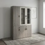 3-door wooden executive cabinet featuring a two-tone finish with taupe wood-grain laminate, upper cream-framed glass display doors revealing internal shelving, lower solid wooden doors, modern dark vertical handles, and key-lock security mechanisms.