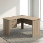 1.2m L-shaped office table featuring a light oak wood-grain laminate finish, a curved corner work surface, a built-in cable grommet, an integrated 3-drawer pedestal unit with lockable storage, sleek metal bar handles, and matching wooden panel legs.