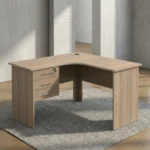 1.2m L-shaped office table featuring a light oak wood-grain laminate finish, a curved corner work surface, a built-in cable grommet, an integrated 3-drawer pedestal unit with lockable storage, sleek metal bar handles, and matching wooden panel legs.