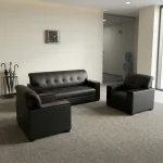 Five seater executive sofa set featuring a 3-seater couch and two matching single armchairs in dark charcoal leatherette, button-tufted backrests and seat cushions, and dark wood-finished wide flat armrests.