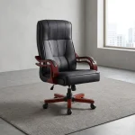 Bliss executive office seat featuring a high-back design upholstered in black leatherette with segmented ergonomic padding, mahogany-finish wooden armrests with chrome support accents, and a mahogany wooden-capped five-star swivel base with caster wheels.