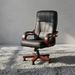 Bliss executive office seat featuring a high-back design upholstered in black leatherette with segmented ergonomic padding, mahogany-finish wooden armrests with chrome support accents, and a mahogany wooden-capped five-star swivel base with caster wheels.