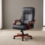 Bliss executive office seat featuring a high-back design upholstered in black leatherette with segmented ergonomic padding, mahogany-finish wooden armrests with chrome support accents, and a mahogany wooden-capped five-star swivel base with caster wheels.