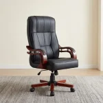 Bliss executive office seat featuring a high-back design upholstered in black leatherette with segmented ergonomic padding, mahogany-finish wooden armrests with chrome support accents, and a mahogany wooden-capped five-star swivel base with caster wheels.