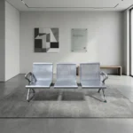 3-seater heavy-duty bench featuring perforated silver steel contoured seats and backrests, curved side armrests, and a durable steel beam support frame with adjustable blue-accented leveling feet.