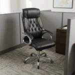 High back leather executive chair featuring a dark charcoal leatherette upholstery with diamond-tufted backrest detailing and contrast stitching, padded loop armrests on silver-finished frames, pneumatically adjustable height controls, and a polished chrome five-star swivel base with caster wheels.