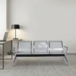 Non-padded steel waiting bench featuring a 3-seater design with perforated silver metallic seats and backrests, curved chrome armrests, a sturdy crossbar beam support, and angled chrome legs with non-marking foot glides.