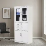 Lockable office cabinet with safe featuring an all-white powder-coated steel construction, upper glass-panel double doors with internal shelving, a middle section with three stacked pull-out drawers alongside a lockable single-door safe compartment, and a lower set of lockable solid double doors.