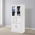 Lockable office cabinet with safe featuring an all-white powder-coated steel construction, upper glass-panel double doors with internal shelving, a middle section with three stacked pull-out drawers alongside a lockable single-door safe compartment, and a lower set of lockable solid double doors.