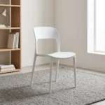White plastic stackable chair featuring a minimalist molded matte white polypropylene single-piece construction, curved backrest with a lower rectangular cutout, contoured seat, and integrated tapered legs.