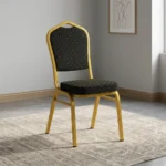 Stackable black banquet chair featuring black fabric upholstery patterned with gold polka dots, a padded crown-back backrest and seat, and a sturdy gold-finished metallic frame.