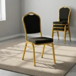 Black stackable conference chair featuring black fabric upholstery patterned with gold polka dots, a padded crown-back backrest and seat, and a durable gold-finished metal frame.
