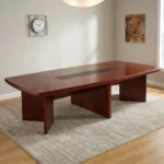 3000mm meeting conference table featuring a rich mahogany wood-grain finish, boat-shaped tabletop with rounded corners, a central black slatted cable management channel, and three robust panel pedestal bases.