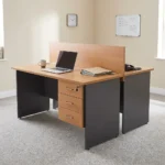 2-way wooden modular workstation featuring a face-to-face dual-person design, light natural oak tabletop finish, a central full-length wooden privacy divider panel, grey panel legs, integrated cable grommets on each desktop, and built-in 3-drawer lockable storage pedestals.