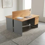 2-way wooden modular workstation featuring a face-to-face dual-person design, light natural oak tabletop finish, a central full-length wooden privacy divider panel, grey panel legs, integrated cable grommets on each desktop, and built-in 3-drawer lockable storage pedestals.