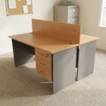 2-way wooden modular workstation featuring a face-to-face dual-person design, light natural oak tabletop finish, a central full-length wooden privacy divider panel, grey panel legs, integrated cable grommets on each desktop, and built-in 3-drawer lockable storage pedestals.