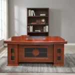 Executive 1800mm office table featuring a classic polished reddish-brown cherry wood finish, a gently curved front desktop with an embedded dark writing pad and cable grommets, decorative modesty paneling with dark inlay accents, and side pedestal bases.