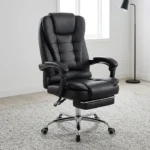 High-back ergonomic leather chair featuring plush black bonded leather upholstery with segmented horizontal padding, an integrated thick headrest, padded loop armrests, a retractable fold-out footrest under a double-padded seat cushion, and a polished chrome five-star base on smooth-rolling dual-wheel casters.
