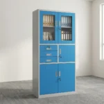 Blue office cabinet with safe featuring a steel construction with a white outer frame and vibrant blue doors/drawers, upper glass-panel double doors with key lock, a middle section with three stacked drawers on the left and a single lockable safe compartment on the right, and lower solid metal double doors with key lock.