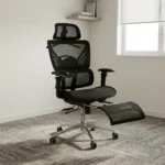 Recliner orthopedic chair with footrest featuring a breathable full-black mesh construction, an adjustable mesh headrest, a multi-segmented high backrest with specialized lower lumbar support, 3D adjustable armrests, a retractable mesh footrest, and a polished metallic five-star base on smooth-rolling casters.