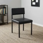Black stackable catalina chair featuring a minimalist armless steel frame with a black powder-coated finish, a padded black faux leather low-profile backrest, a thick cushioned seat, and straight square legs.