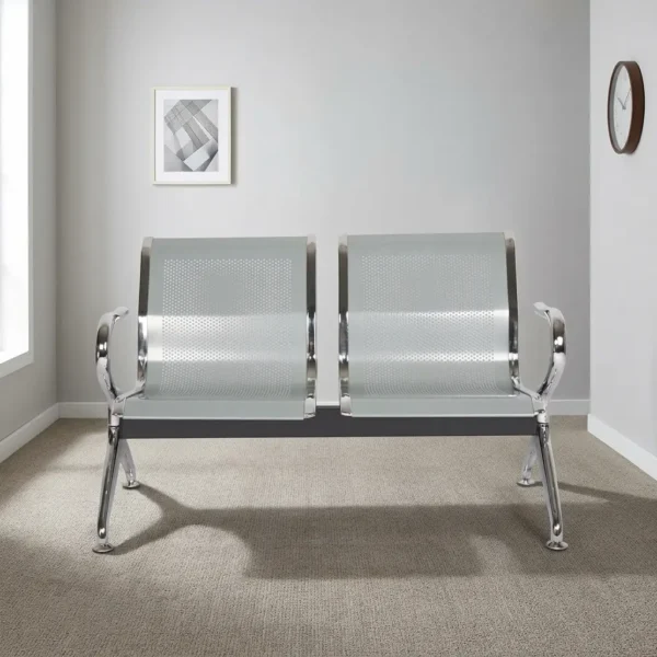 Two seater waiting bench featuring a 2-seater gang design, perforated silver-grey metallic seat shells with polished chrome borders, curved chrome end armrests, and a sturdy metallic beam frame supported by angled chrome legs with adjustable levelling feet.