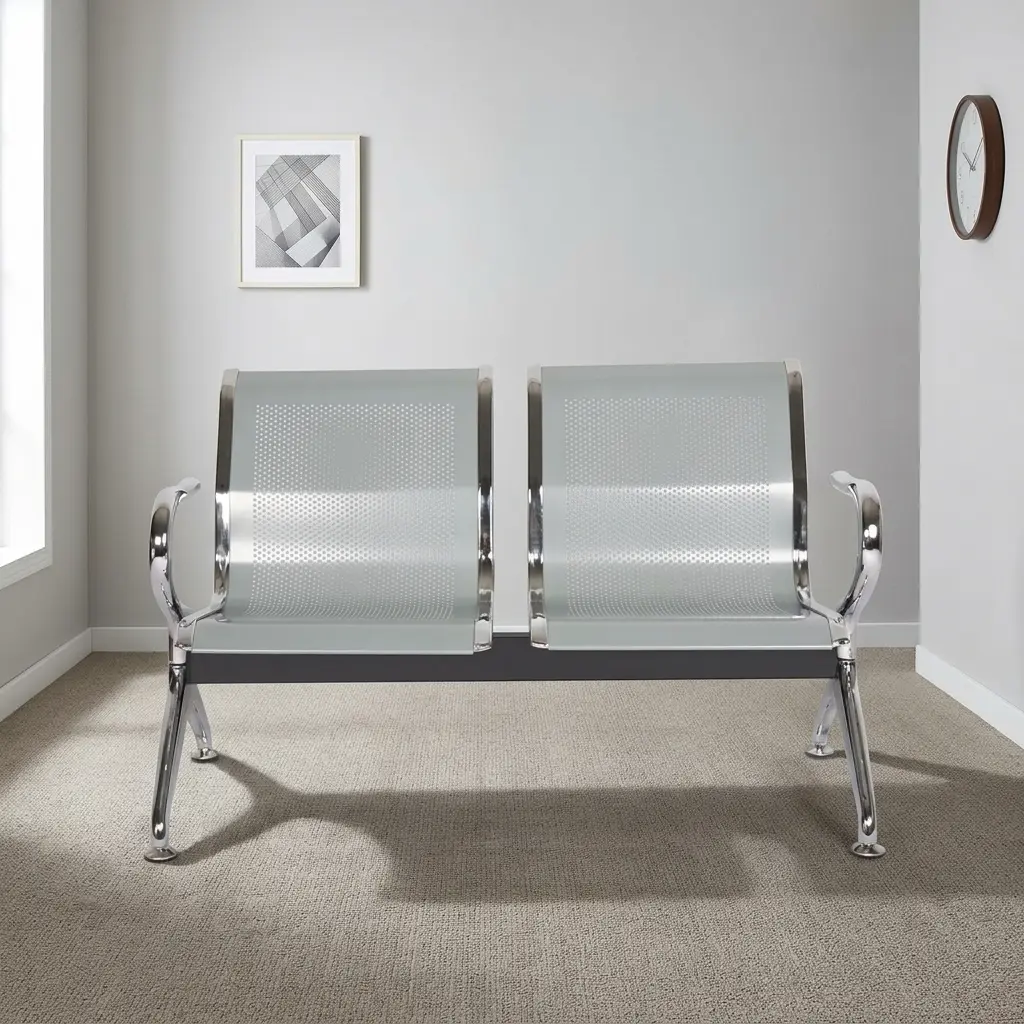 Two seater waiting bench featuring a 2-seater gang design, perforated silver-grey metallic seat shells with polished chrome borders, curved chrome end armrests, and a sturdy metallic beam frame supported by angled chrome legs with adjustable levelling feet.