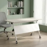 120cm foldable training table featuring a rectangular white laminate tabletop with a black edge band, integrated onto a white metal nesting frame with a matching solid white modesty panel, supported by angled T-legs equipped with dual-wheel locking casters.