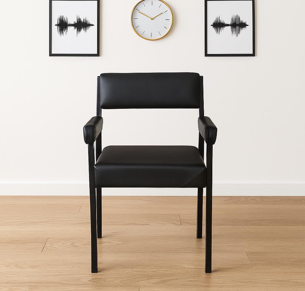 Catalina visitor chair with arms featuring smooth black leatherette upholstery, a padded low-profile backrest, a thick cushioned seat, fully upholstered rectangular arm pads, and a durable black powder-coated metal four-legged frame.