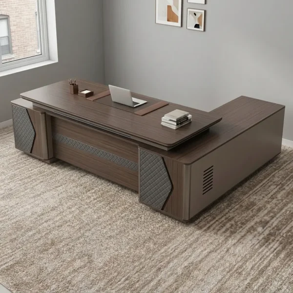 L-shaped 2400mm office table featuring a dark walnut wood-grain desktop with an integrated leatherette writing pad inlay, a modesty panel with a horizontal textured accent stripe, diamond-quilted decorative side pillar panels, and an extended side return cabinet providing multi-functional storage.