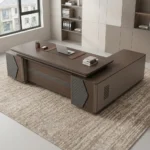 L-shaped 2400mm office table featuring a dark walnut wood-grain desktop with an integrated leatherette writing pad inlay, a modesty panel with a horizontal textured accent stripe, diamond-quilted decorative side pillar panels, and an extended side return cabinet providing multi-functional storage.
