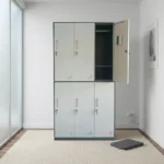 6-locker steel filing cabinet featuring a two-tier layout with light gray doors set in a dark gray metallic frame, individually lockable compartment doors equipped with recessed handles, key locks, card/label holders, ventilation louvers, and interior storage shelving with a hanging rod.