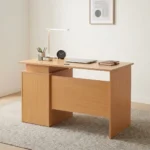 1.2m wooden office table featuring a light oak wood finish, a rectangular desktop with a circular wire management grommet, a half-height modesty panel, and an integrated side pedestal with three lockable drawers with metal bar handles.