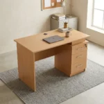 1.2m wooden office table featuring a light oak wood finish, a rectangular desktop with a circular wire management grommet, a half-height modesty panel, and an integrated side pedestal with three lockable drawers with metal bar handles.