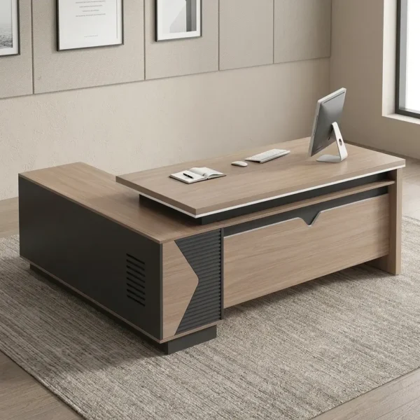 1.8m managerial executive office desk featuring a modern L-shaped design in natural wood grain and charcoal grey finishes, a floating-style primary desktop with a raised under-frame, an integrated low-profile side return cabinet with ventilation slats and geometric accent paneling, and a matching front modesty panel with a decorative top cutout.