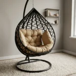 High quality hammock swing featuring a teardrop-shaped dark brown woven wicker egg chair, a thick tufted beige cushion set, and a heavy-duty black metal hanging stand with a circular base.