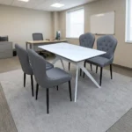 4-seater dining set featuring a rectangular white marble-patterned tabletop with white geometric angled metal legs, paired with four grey leatherette upholstered chairs with button-tufted inner backrests and tapered black legs.