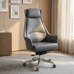 High back executive boss office chair featuring slate grey leather upholstery with an integrated padded headrest, contoured high-back shell with padded flared armrests, pneumatic tilt and height control mechanism, and a polished chrome five-star swivel base on dual-wheel casters.